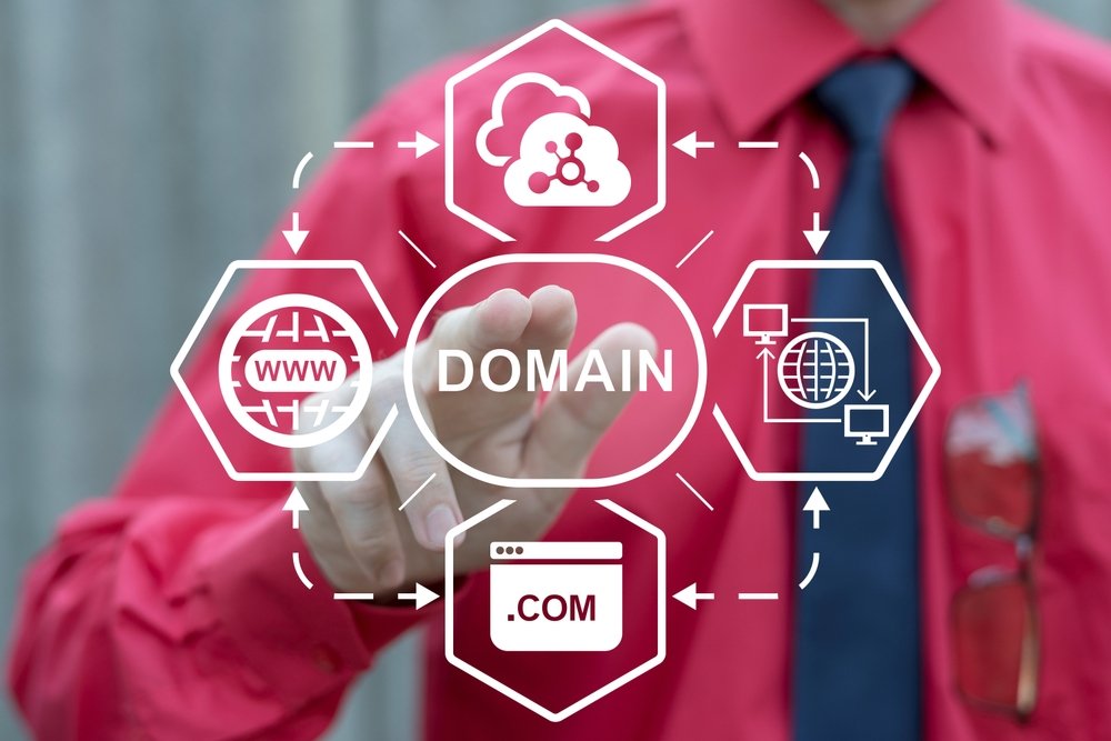 Business professional interacting with a virtual touchscreen displaying HOSTING AND DOMAIN concepts, including .com registration, website hosting, and internet technology icons.