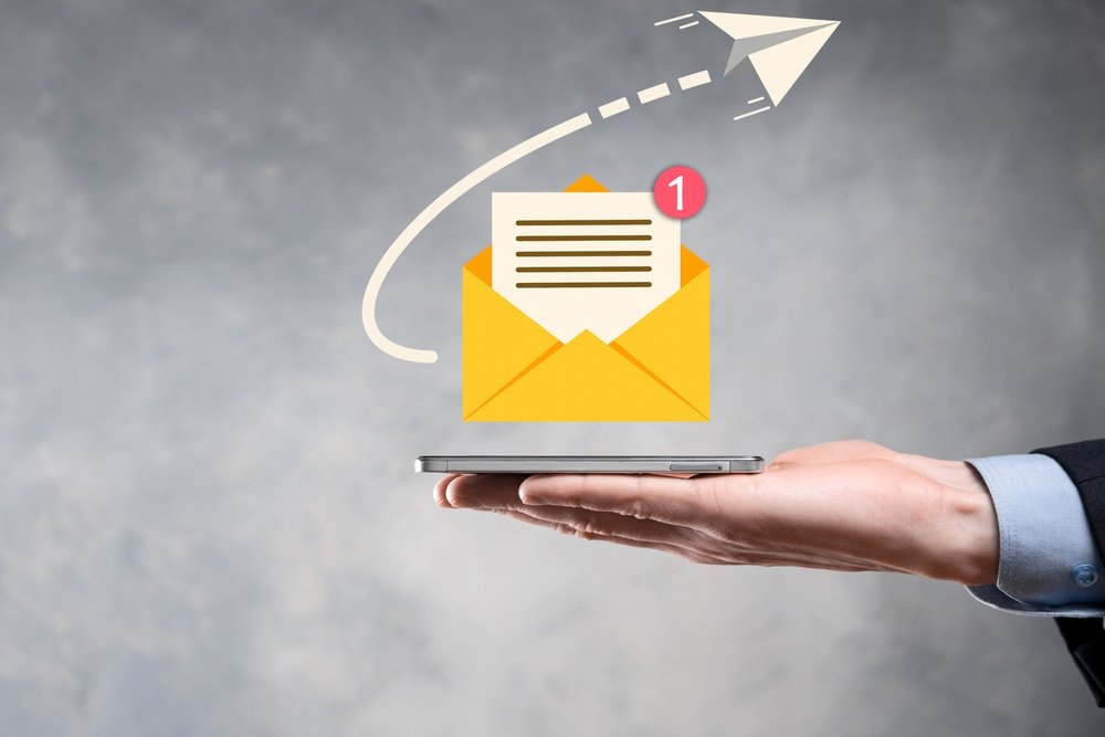 Businessman hand holding e-mail icon, Contact us by newsletter email and protect your personal information from spam mail. Customer service call center contact us concept.