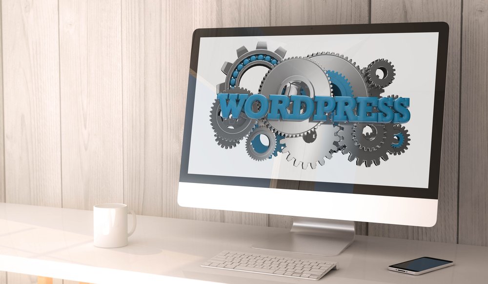 Desktop workspace showing WordPress as the best CMS for business websites with gear mechanisms