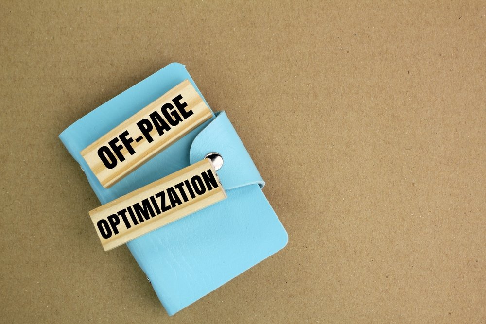 Off-Page SEO Strategy for Small Businesses concept showing off-page optimization text blocks on a notebook, representing backlink building, local SEO, citations, and search engine ranking improvement.