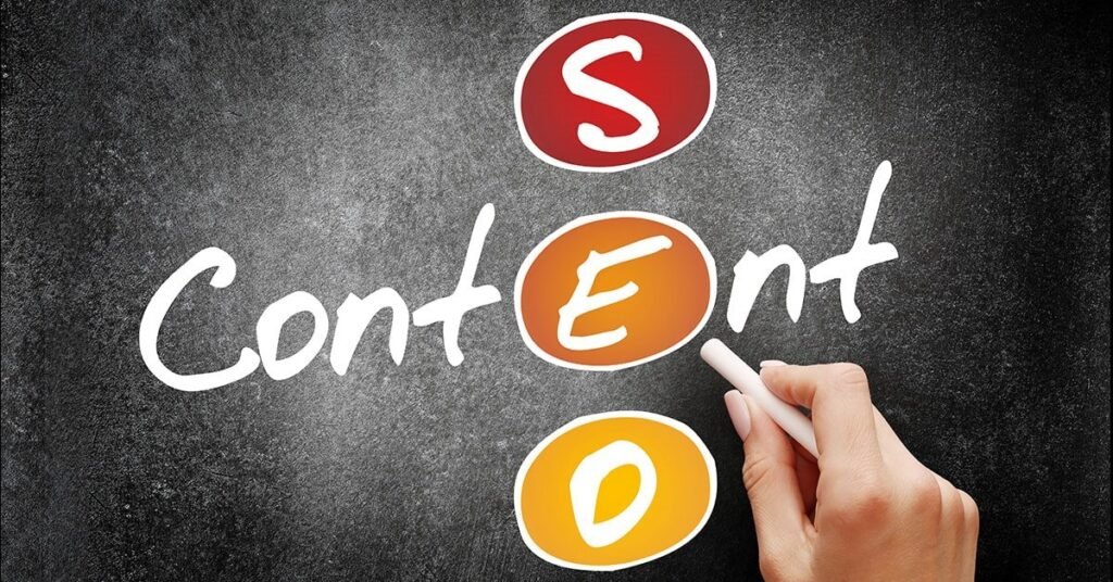 A hand writing the word Content on a chalkboard with SEO letters highlighted in colorful circles, representing SEO content writing